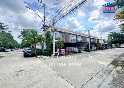 Street view of residential area with houses and cars