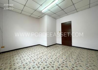 Empty room with tiled floor and wooden door