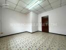 Empty room with tiled floor and wooden door