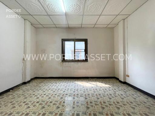 Unfurnished room with window and patterned floor tiles