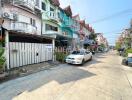 View of a residential neighborhood street with parked cars