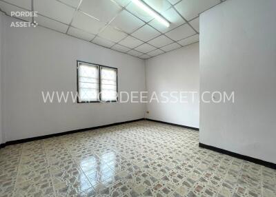 Empty bedroom with tiled floor and window