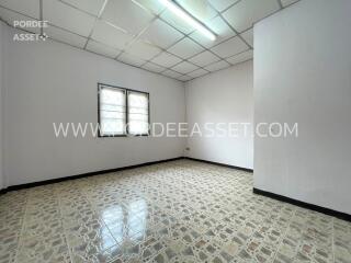 Empty bedroom with tiled floor and window