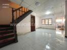 Spacious living room with staircase