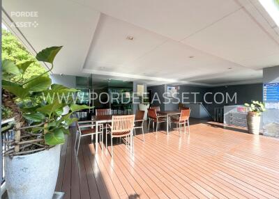 Outdoor patio with wooden flooring and seating area