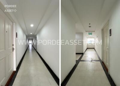 Hallway with white walls and tiled floor