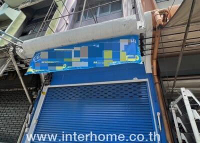 Building exterior with blue roller shutter and signage