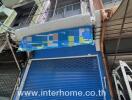 Building exterior with blue roller shutter and signage