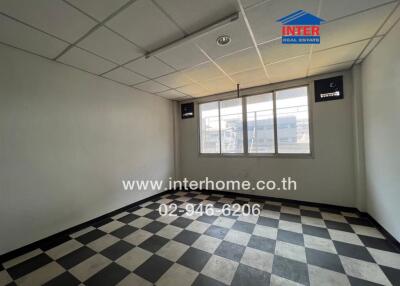 Empty room with checkered floor and large window