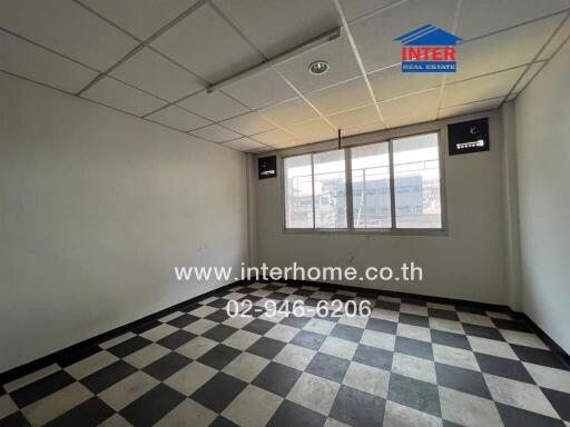 Empty room with checkered floor and large window