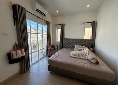 Modern bedroom with large window and balcony access