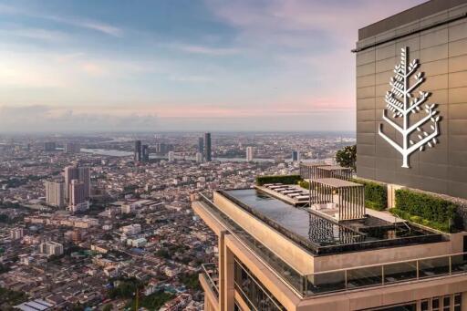 High-rise building with rooftop pool overlooking city skyline