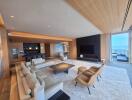 Modern spacious living room with wooden ceiling and ocean view