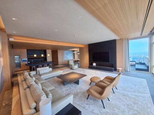 Modern spacious living room with wooden ceiling and ocean view