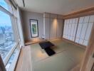 Modern Japanese-style living room with tatami mats and city view