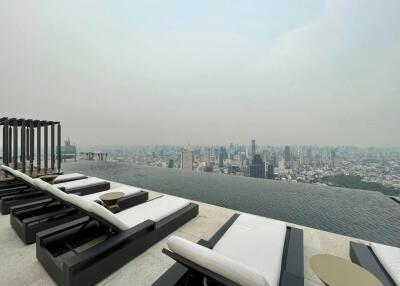 Rooftop view with lounge chairs and infinity pool