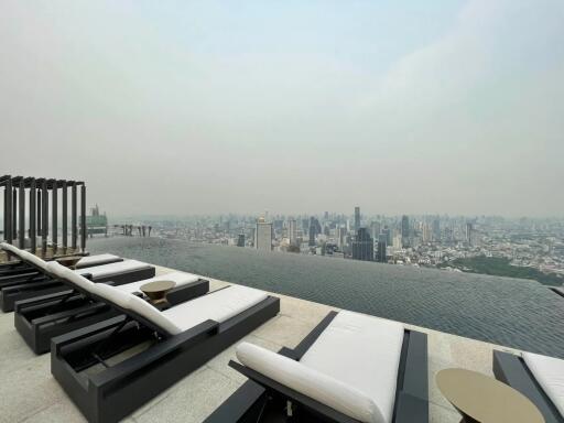 Rooftop view with lounge chairs and infinity pool