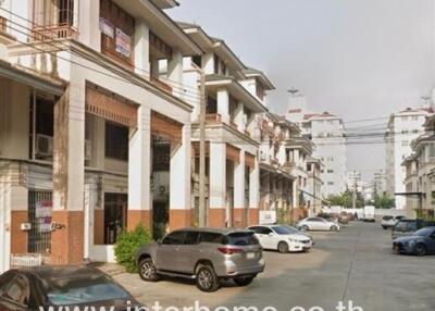 Exterior view of residential buildings with parked cars