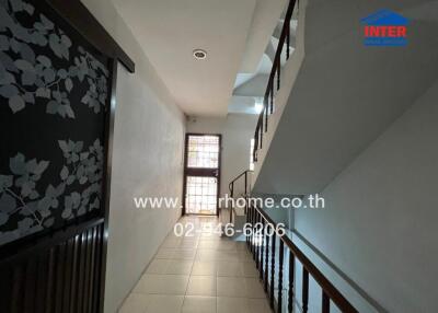 Interior hallway with stairs leading to upper floor