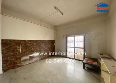 Spacious living room with tiled wall and large window