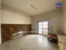 Spacious living room with tiled wall and large window