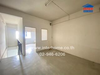 Empty hallway with a view into a bedroom