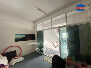 Living area with large sliding glass door and stairway view