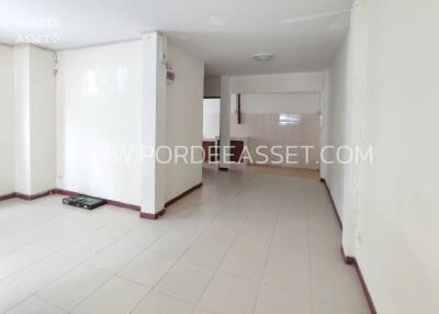 Spacious empty living area with tiled floor