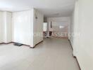 Spacious empty living area with tiled floor