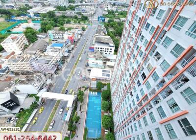 Aerial view of a high-rise apartment building and surrounding area