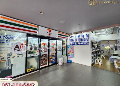 Exterior view of a commercial building with a convenience store and laundry service.