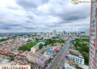 Aerial view of the city showing buildings, roads, and a cloudy sky