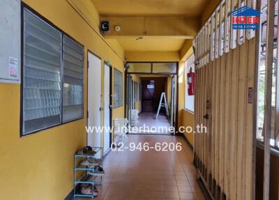 Hallway with yellow walls and tiled floor