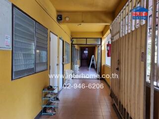 Hallway with yellow walls and tiled floor