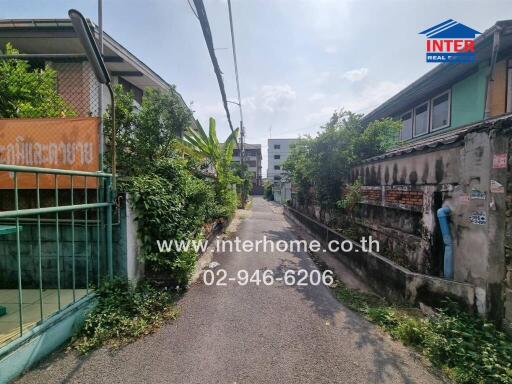 Narrow street view with greenery and buildings