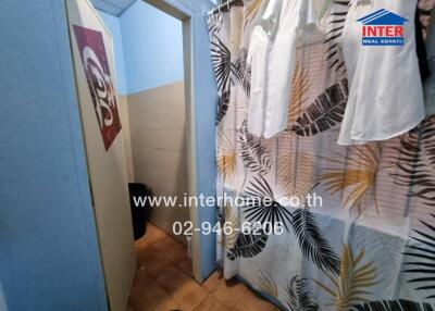 Bathroom with decorative curtain and tiled floor