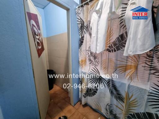 Bathroom with decorative curtain and tiled floor