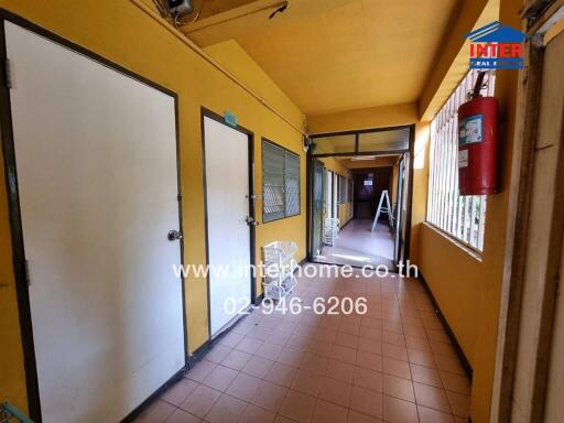 Hallway with multiple doors and windows