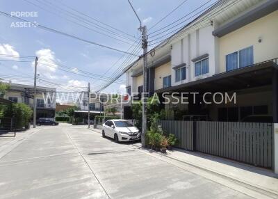 Modern townhouse with parked car and driveway