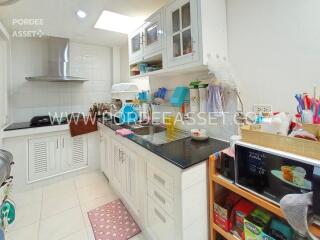 Compact and modern kitchen with white cabinetry and black countertop