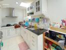 Compact and modern kitchen with white cabinetry and black countertop