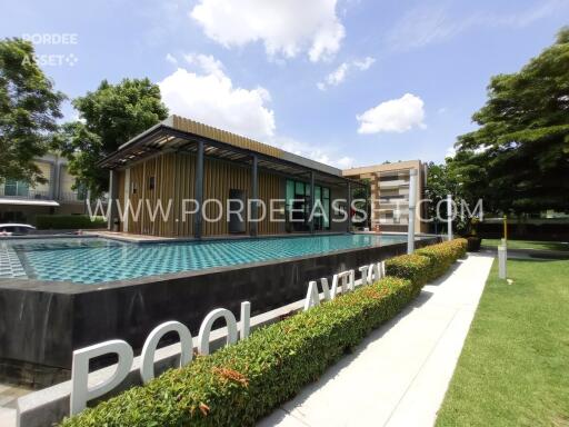 Outdoor pool and modern building with greenery