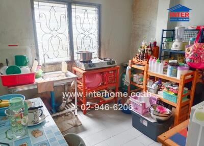 Small kitchen with various appliances and storage solutions