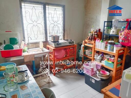 Small kitchen with various appliances and storage solutions