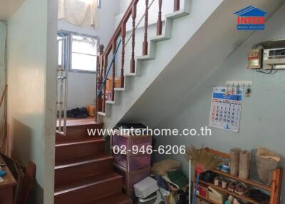 Interior view showcasing staircase and under-stair storage area