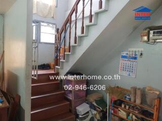 Interior view showcasing staircase and under-stair storage area