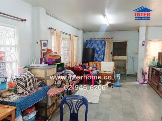 Interior view of a cluttered living area with furniture and household items