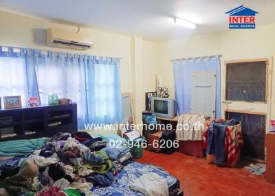 bedroom with a bed, shelves, air conditioner, and TV