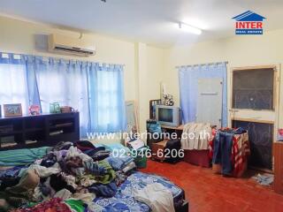 bedroom with a bed, shelves, air conditioner, and TV