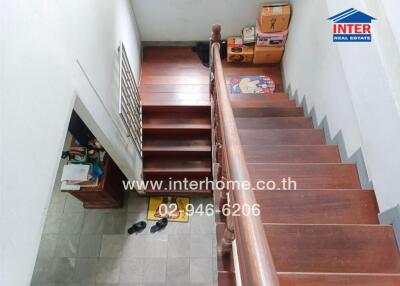 Staircase with wooden steps and storage area